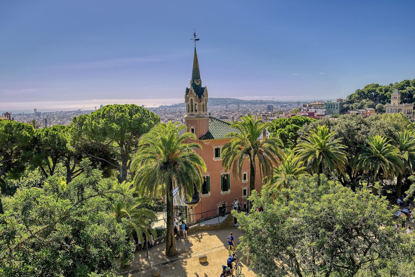 Gaudí House Museum among trees above the city.