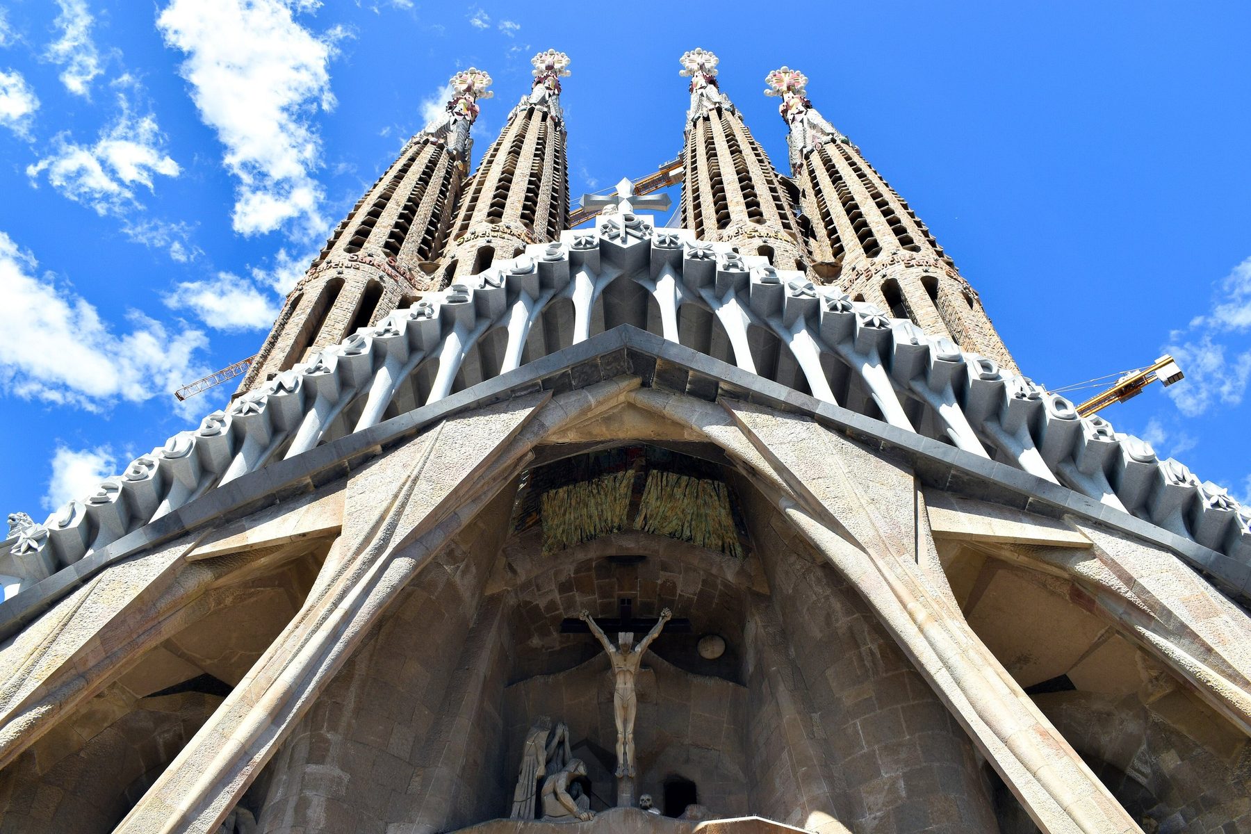 Passion façade and four bell towers under blue sky.