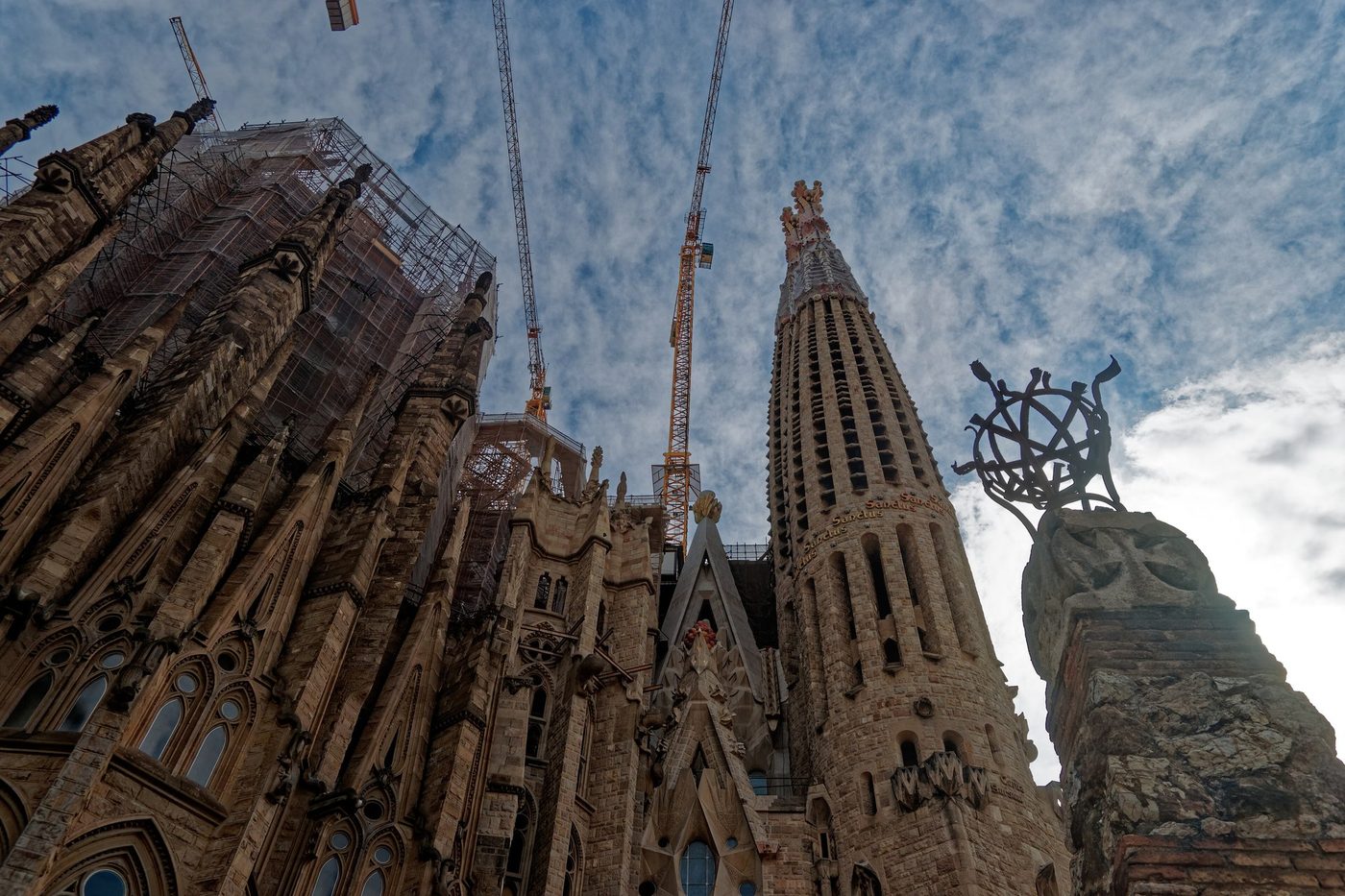 Towers from below, with a sculpture in front