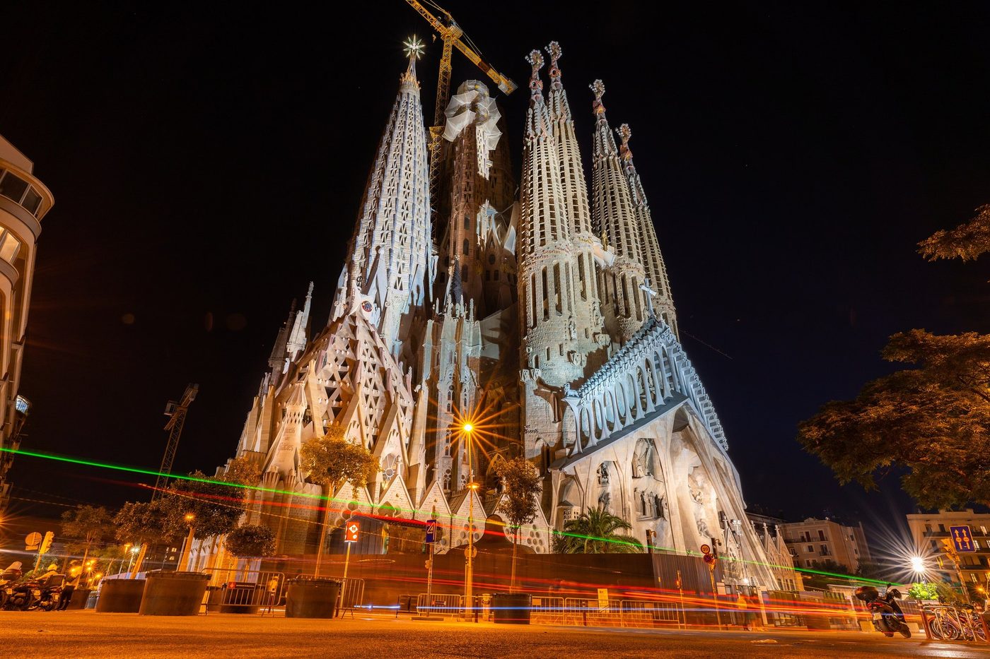 The lit Basilica with crane and car light trails