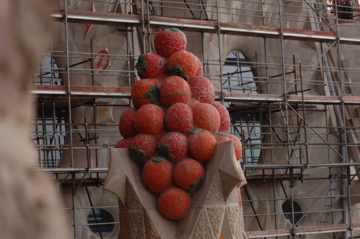 Red and orange mosaic fruit above a pinnacle