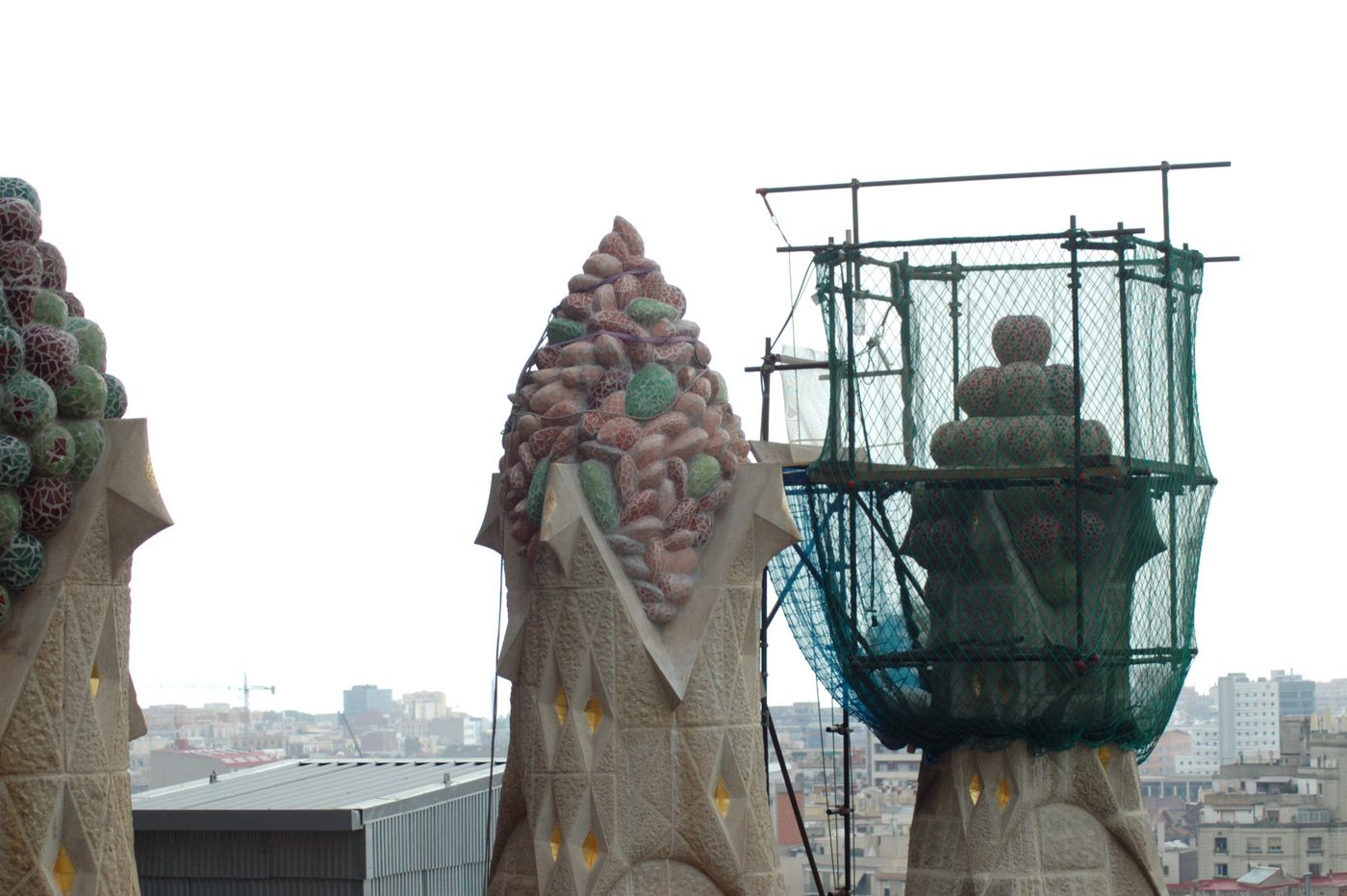 Mosaic fruit and a basket atop pinnacles in scaffolding