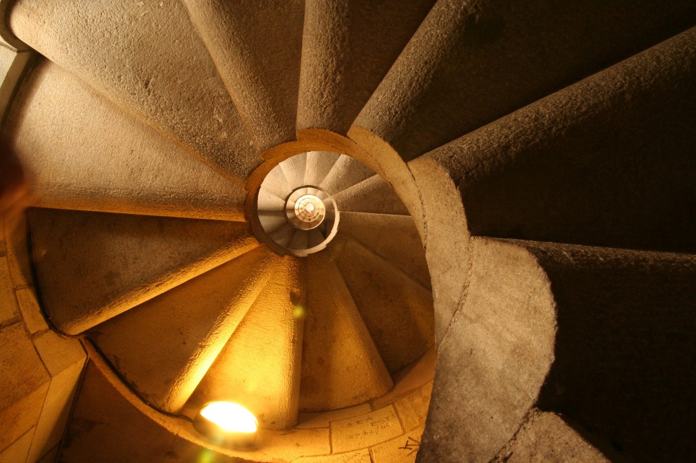 A spiral staircase in warm light from below